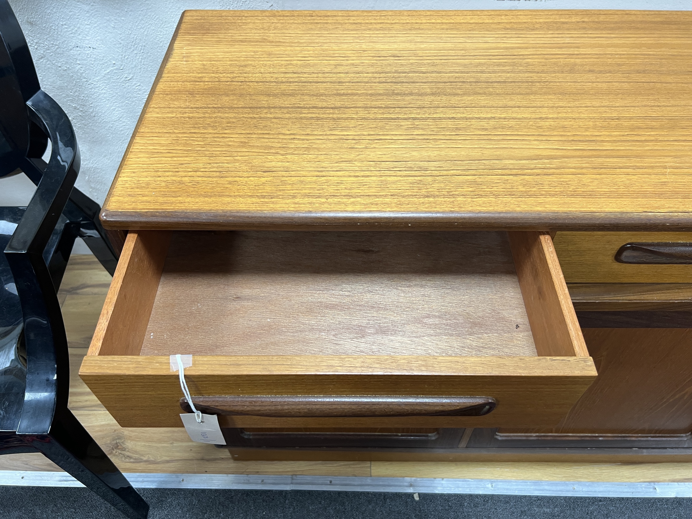 A mid century G Plan teak sideboard, length 142cm, depth 44cm, height 76cm